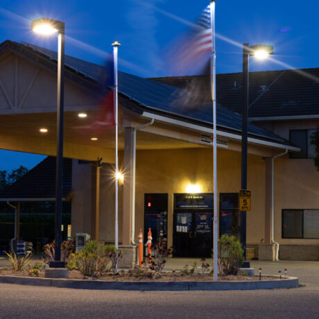 View of the flags waving an RV Sites at Flag City RV Resort in Lodi, CA.