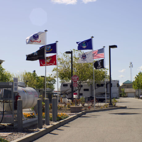 View of the flags waving an RV Sites at Flag City RV Resort in Lodi, CA.
