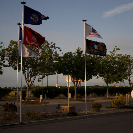 View of the flags waving at Flag City RV Resort in Lodi, CA.