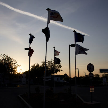 View of the flags waving at Flag City RV Resort in Lodi, CA.