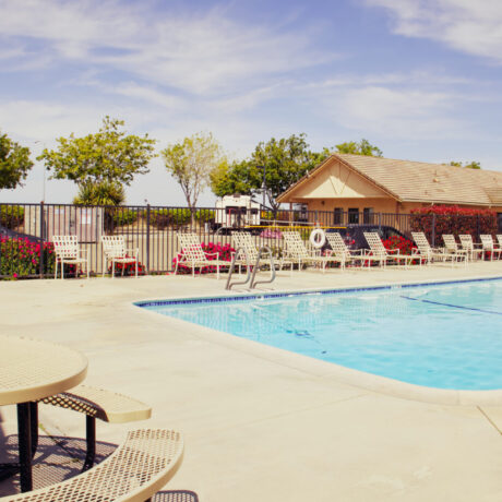 A sparkling pool surrounded by clean, modern facilities at Flag City RV Resort in Lodi, CA.