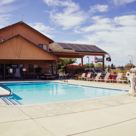 A sparkling pool surrounded by clean, modern facilities at Flag City RV Resort in Lodi, CA.