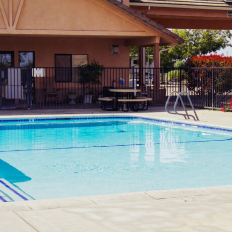 A sparkling pool surrounded by clean, modern facilities at Flag City RV Resort in Lodi, CA.